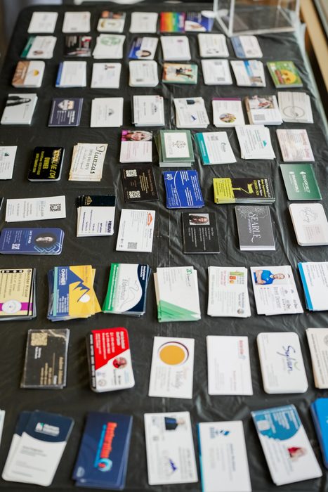 Business cards laid out on a table for attendees to browse