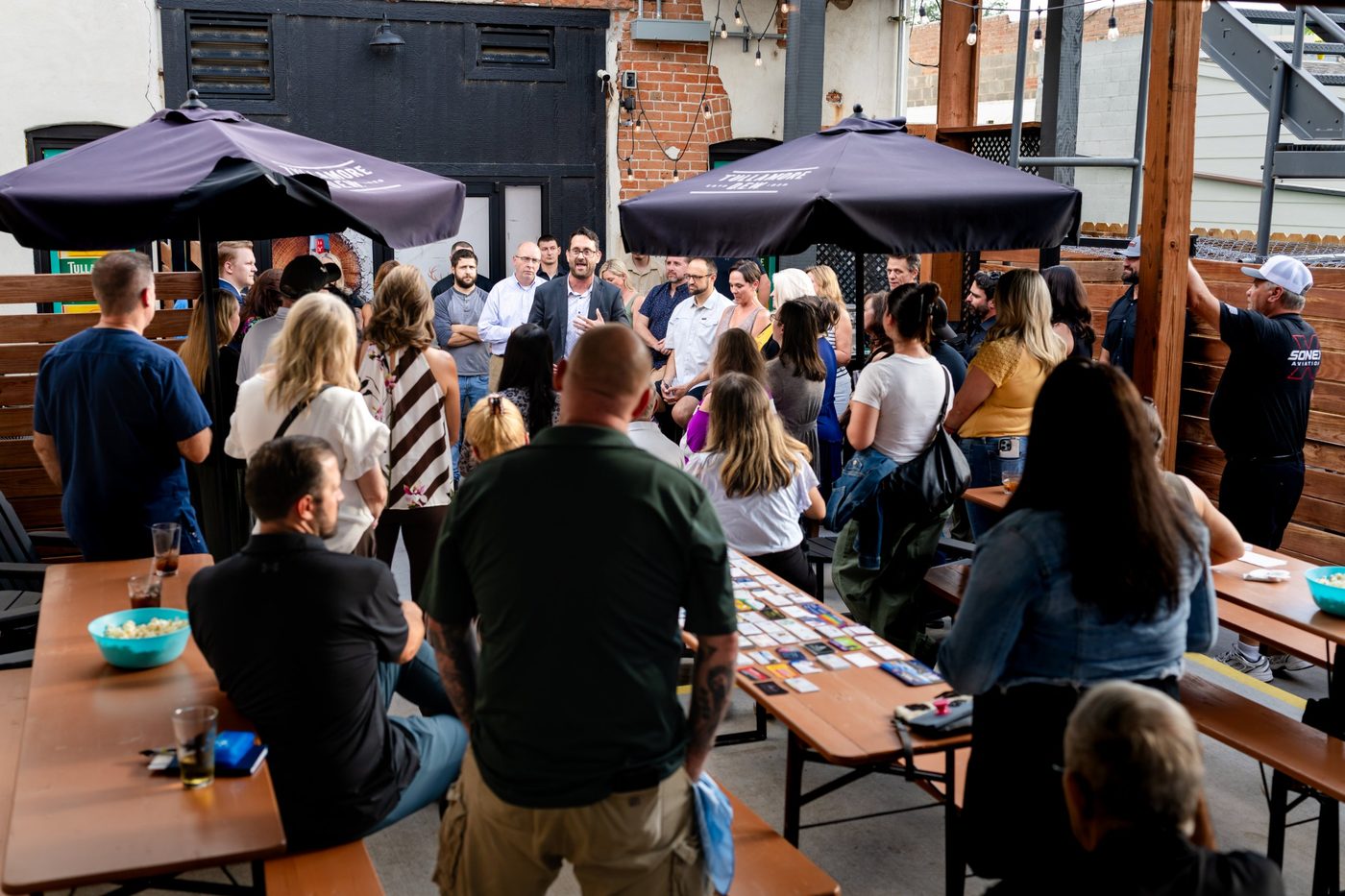A speaker addressing the crowd at a SURE Networking mixer