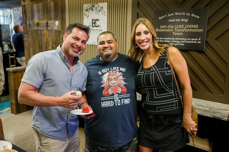 Three attendees smiling for a photo